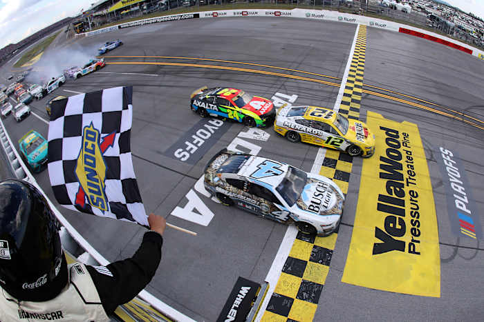 Ryan Blaney crosses the finish line ahead of Kevin Harvick to win Sunday's NASCAR Cup Series YellaWood 500 at Talladega Superspeedway, sending Blaney onto the Round of 8 in the playoffs. Meanwhile, Harvick's car was disqualified after post-race inspection. (Photo by Meg Oliphant/Getty Images)